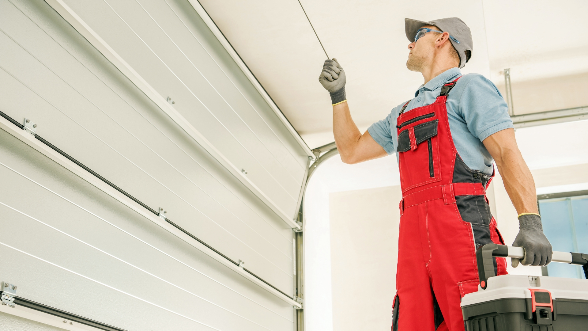 A technician performing a garage door service in Denver